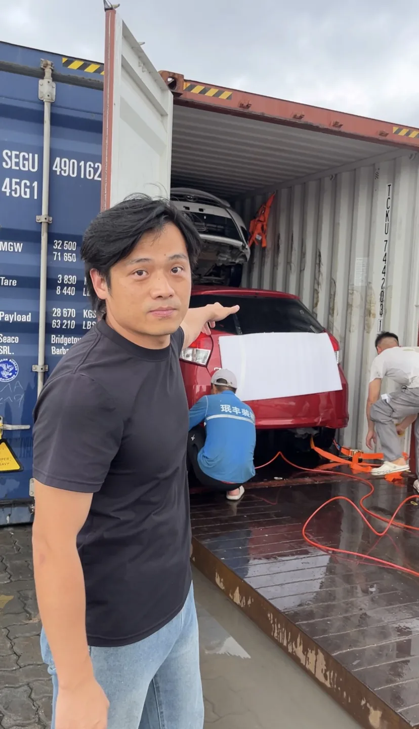 Jiang beside a loaded vehicle